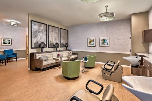 Modern salon lounge with seating and hair styling stations