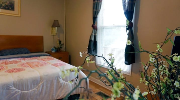 Cozy resident room with floral decor and window light