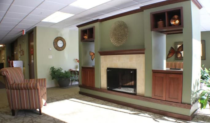 A cozy lobby with a fireplace and seating area