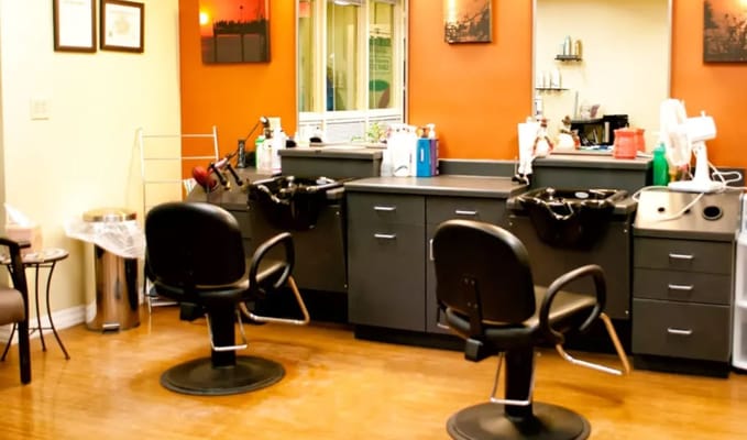 Interior view of the hair salon with styling chairs and equipment