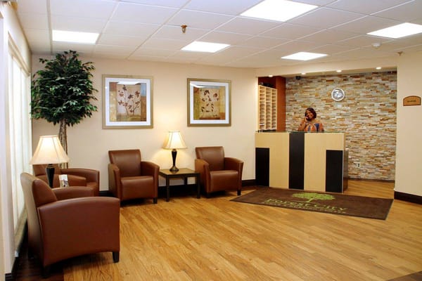 Bright reception area with seating and friendly staff member