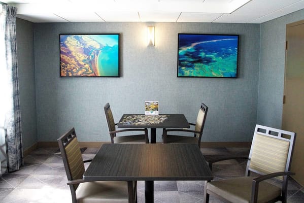 Bright activity room with puzzle and artwork