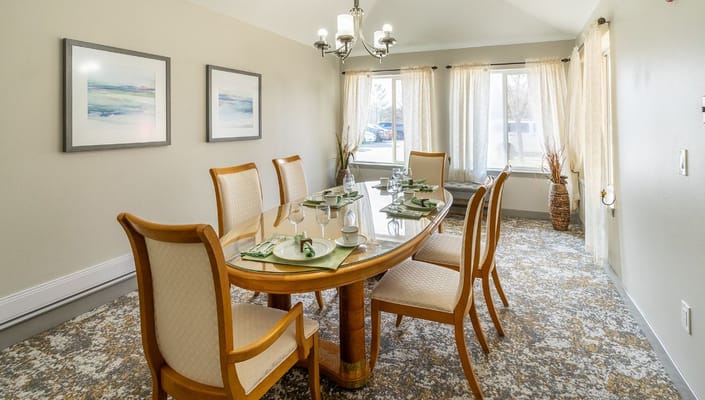 Elegant dining room set with chairs and table at Holiday Genesee Gardens.