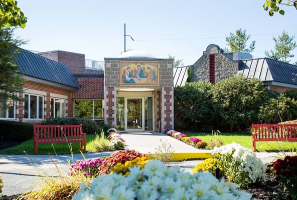 Front entrance with a mural and landscaped garden