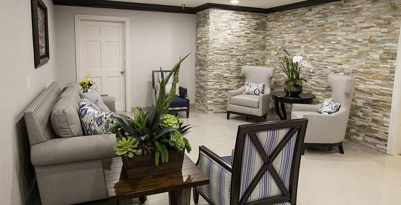 A cozy common area with seating and decorative plants