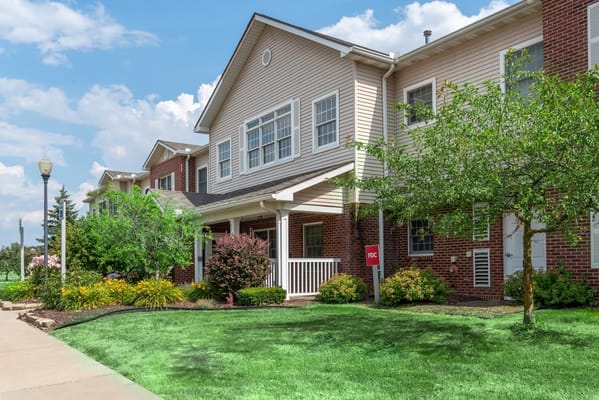 The entrance of the Landings of Genesee Valley senior living facility with landscaped garden.