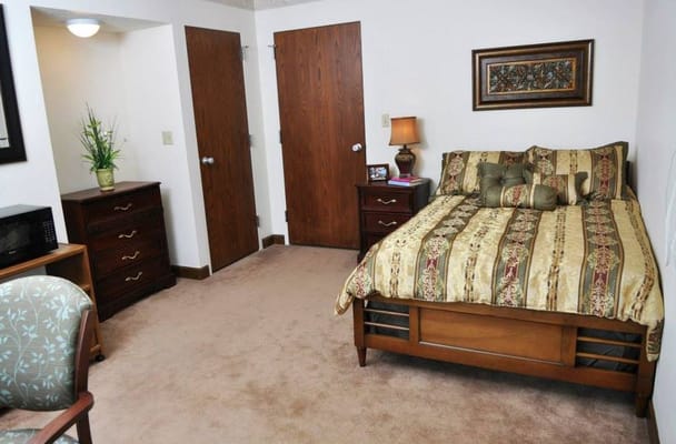 Cozy private resident room with a bed and furniture