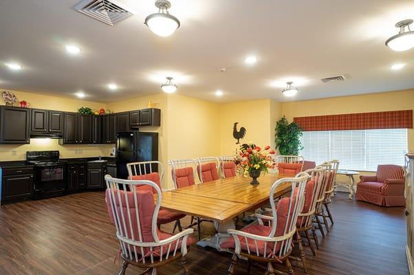 Interior dining area with a large table and kitchen