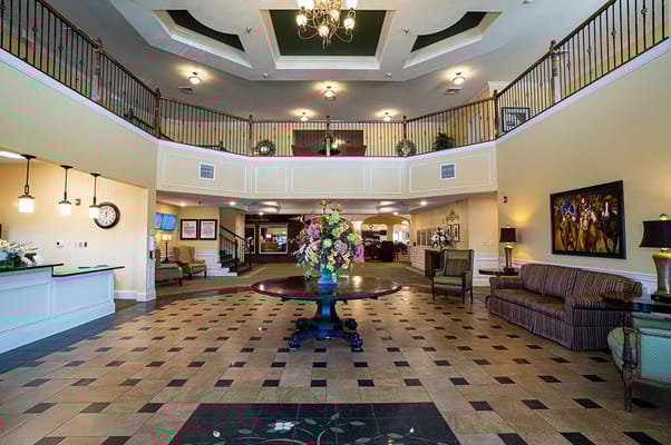Bright lobby area with floral arrangement and seating