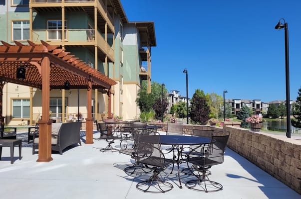 Outdoor patio area with seating near the water
