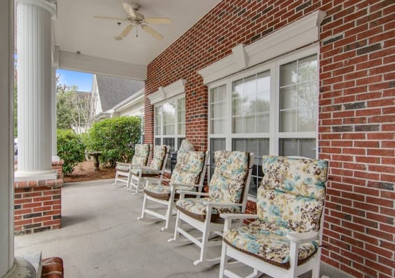 Rocking chairs on a porch outside the facility