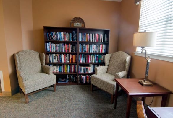 Cozy reading nook with bookshelves and armchairs