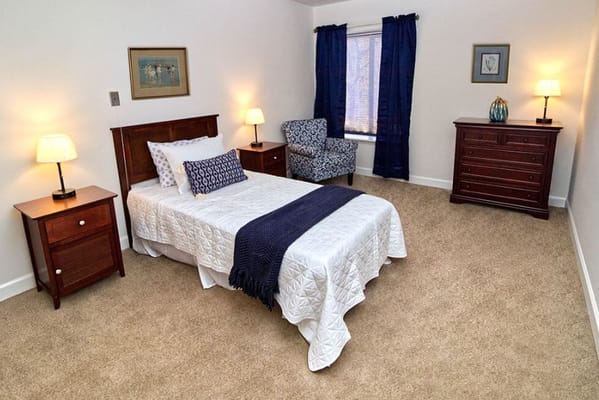 Private resident room with a bed and chair