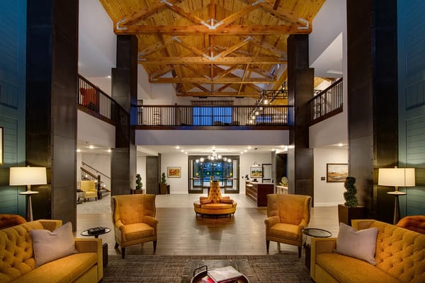 Welcoming lobby with comfortable seating and wooden ceiling