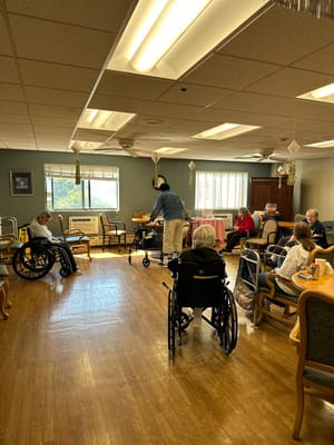 Residents engaged in a communal activity in the lounge.