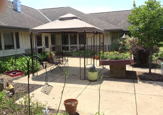 Outdoor garden area with gazebo and plants