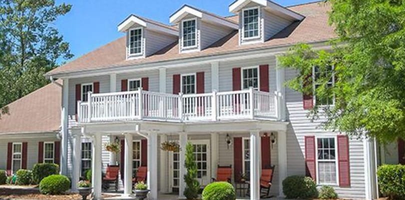 Exterior view of a senior living facility with landscaping