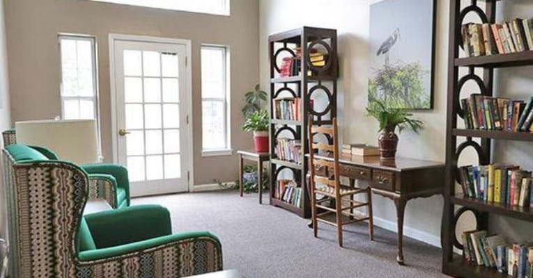 Bright common area with seating and bookshelves