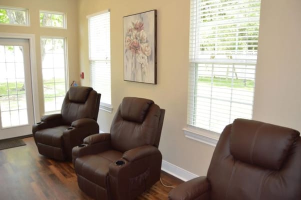 Three reclining chairs in a brightly lit lounge