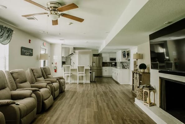 Living room with recliners and open kitchen area