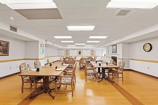 Spacious dining area with floral chairs and tables