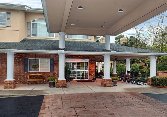 Entrance view of The Bridge at Charleston with rocking chairs