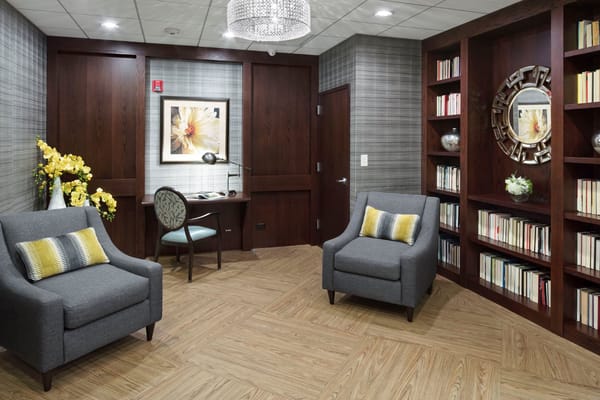 Comfortable seating area with a desk and bookshelf in the library