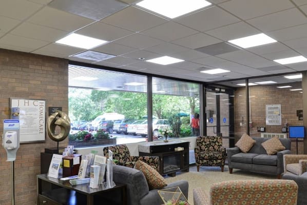 Bright and welcoming lobby with seating area and view of outside gardens