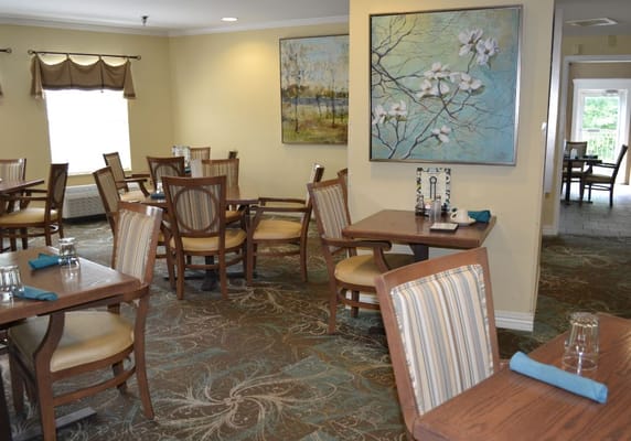 Dining area with tables and artwork on the walls