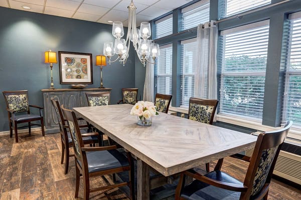 Dining area with a large table and decorative chairs