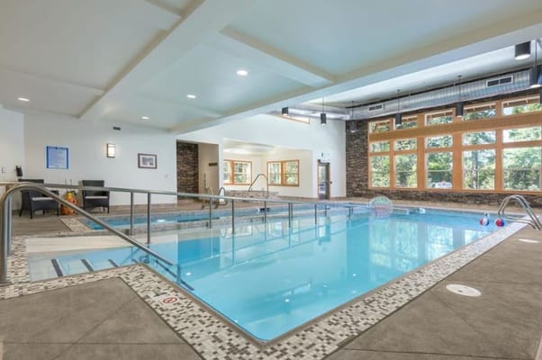 Indoor swimming pool area with large windows