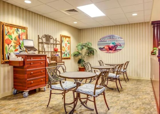 Cozy seating area in the Triple Crown Parlor with floral artwork