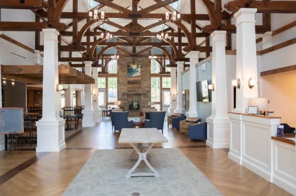 Spacious lobby with wooden beams and seating area