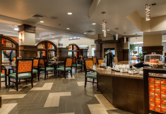 Cozy lounge with colorful seating and a coffee station