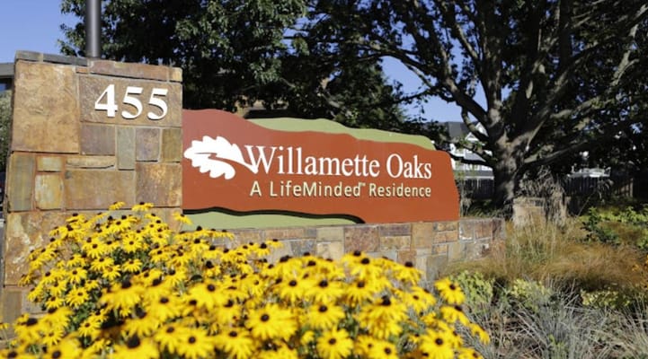 Exterior sign of Willamette Oaks with flowers