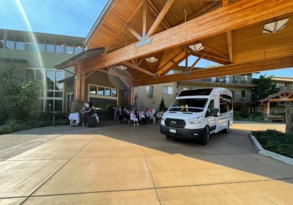Residents and staff gathered under the facility's entrance