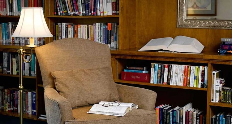 Cozy reading corner with bookshelves in a library