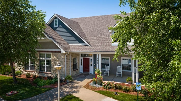 Exterior view of assisted living facility with gardens