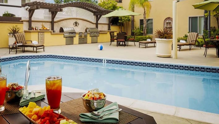 Outdoor pool area with food and drinks served
