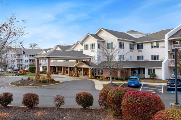 Exterior view of a senior living facility with landscaped grounds
