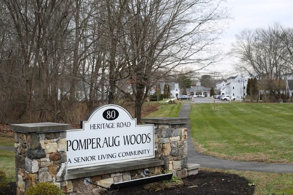 Sign for Pomperaug Woods senior living community