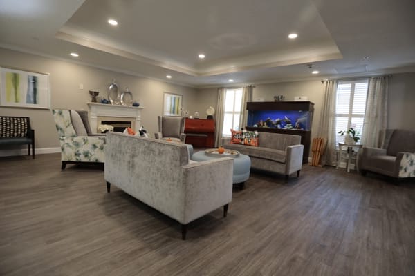 A cozy common area with seating and an aquarium.