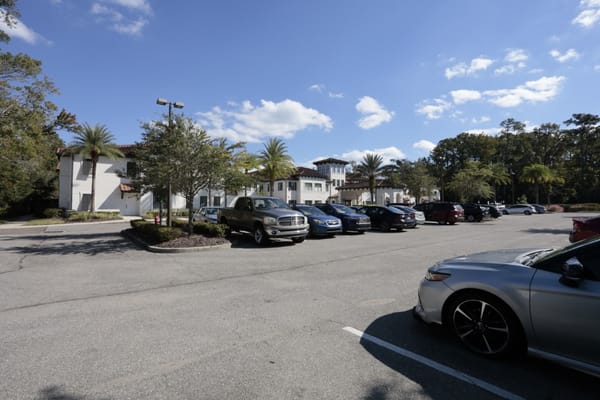 Outdoor parking area at Starling at San Jose with various vehicles parked.