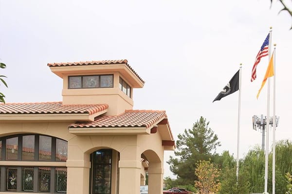 Exterior view of facility entrance with flags