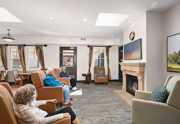 Residents relaxing in a common area with natural light