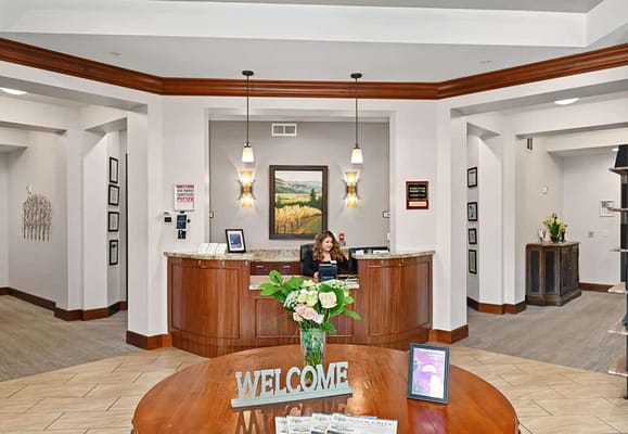 Reception area with staff and flowers welcoming residents