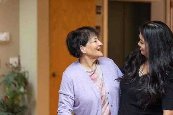 Two women interacting in a common area