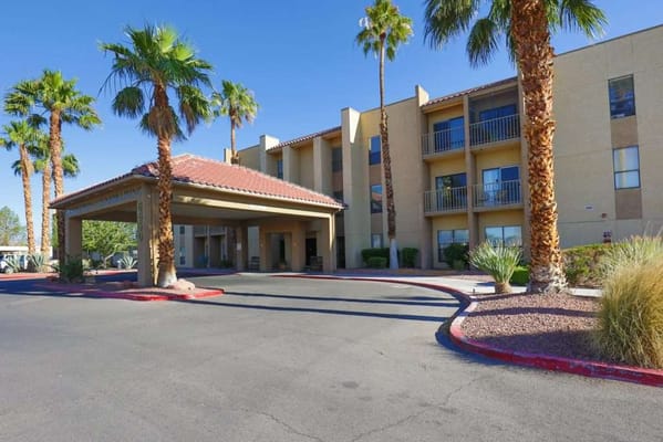 Entrance of Desert Spring Senior Living facility with palm trees