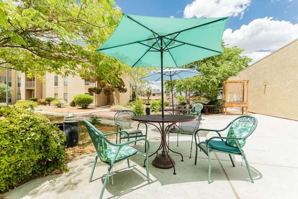 A serene outdoor patio with seating and umbrellas