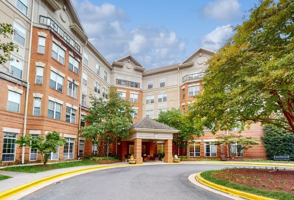 Exterior view of a senior living facility with landscaped entryway